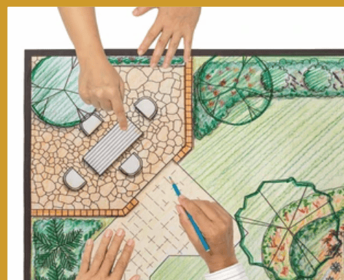 AmpPavers_Your Project: Colored pencil drawing of landscape with grass, paver patio with stone walls, and paver pathway laying flat with two pairs of hands across from each other pointing to different paver areas of drawing